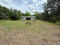 Large backyard with a detached building and space for outdoor activities at 3625 Pioneer Trl, New Smyrna Beach, FL 32168