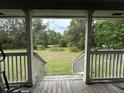Inviting front porch showcasing a view of the expansive front yard at 3625 Pioneer Trl, New Smyrna Beach, FL 32168