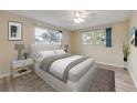 Serene bedroom featuring a large window, ceiling fan, and wood-look flooring at 3718 Paige St, Port Orange, FL 32129