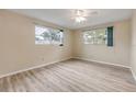Bright bedroom with wood-look flooring and natural light from two windows at 3718 Paige St, Port Orange, FL 32129