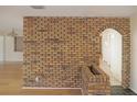 Charming brick accent wall with arched doorway and neutral flooring in the living room at 3736 Paige St, Port Orange, FL 32129