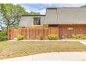 Cozy single-Gathering home featuring a wood fence, and a well-manicured lawn at 3808 Saxon Dr, New Smyrna Beach, FL 32169