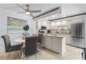 Eat-in kitchen features white cabinets, stainless appliances, and a cozy dining area at 3808 Saxon Dr, New Smyrna Beach, FL 32169