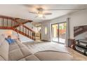 Open living room showcasing sliding glass doors to the outside patio and a staircase at 3808 Saxon Dr, New Smyrna Beach, FL 32169
