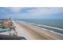 Beach view of ocean waves and shoreline with a blue sky and light clouds above from a high vantage point at 3855 S Atlantic Ave # 1503, Daytona Beach Shores, FL 32118