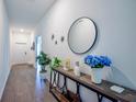 Inviting entryway with elegant console table, decorative mirror, and stylish tile flooring at 3963 Willowbrook Dr, Edgewater, FL 32141
