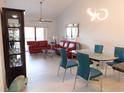 Bright living room featuring a vaulted ceiling, modern lighting, and an adjacent dining area for seamless entertaining at 402 Bouchelle Dr # 205, New Smyrna Beach, FL 32169