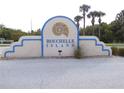 Bouchelle Island sign, trimmed in blue, welcomes residents and guests to this waterfront community at 402 Bouchelle Dr # 205, New Smyrna Beach, FL 32169