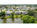 An aerial view of a well-manicured backyard with a lake view and outdoor seating at 404 Central Mariners Dr, Edgewater, FL 32141