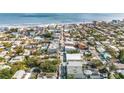 Beautiful aerial view of the neighborhood, showing proximity to the beach and highlighting the quaint streets lined with trees at 415 Jessamine Ave, New Smyrna Beach, FL 32169