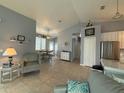 Bright living room with tile floors and open floor plan that leads to the dining area and kitchen at 415 Jessamine Ave, New Smyrna Beach, FL 32169