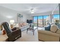Comfortable living room with natural light and relaxing recliner at 4175 S Atlantic Ave # 4050, New Smyrna Beach, FL 32169