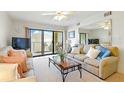 Bright living room with plush seating and ocean view at 4175 S Atlantic Ave # 4050, New Smyrna Beach, FL 32169