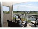 Relaxing screened balcony with comfortable seating and picturesque views of the marina at 426 Bouchelle Dr # 401, New Smyrna Beach, FL 32169
