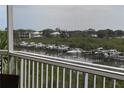 Serene balcony view overlooking the waterfront with boats docked along the canal at 426 Bouchelle Dr # 401, New Smyrna Beach, FL 32169