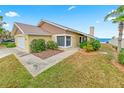 Charming single-story home with lush landscaping and a glimpse of the ocean in the background at 4323 S Atlantic Ave, Port Orange, FL 32127