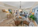 The living room features coastal decor, wood floors, and sliding glass doors to the balcony at 4670 Links Village Dr # D206, Ponce Inlet, FL 32127
