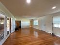 Spacious living room with hardwood floors, bright windows, and open layout, perfect for entertaining at 5018 Riverside Dr, Port Orange, FL 32127
