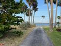Scenic view of a waterfront property with palm trees, city skyline and a tranquil body of water at 5018 Riverside Dr, Port Orange, FL 32127