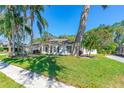 Single-story home exhibiting mature landscaping, with a well-maintained lawn and sidewalk at 6088 Sabal Hammock Cir, Port Orange, FL 32128