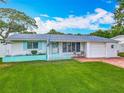 Charming single-story home with a brick driveway, manicured lawn and an attached garage at 805 E 15Th Ave, New Smyrna Beach, FL 32169