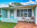 Inviting front porch with patterned concrete blocks and seating area overlooking the landscaped lawn at 805 E 15Th Ave, New Smyrna Beach, FL 32169