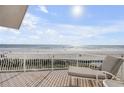 Oceanfront balcony with lounge chair overlooking the beach and glistening ocean at 951 N Atlantic Ave, New Smyrna Beach, FL 32169