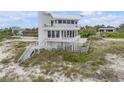 Beautiful, modern home on a sandy beach, showcasing multiple decks and gorgeous views at 951 N Atlantic Ave, New Smyrna Beach, FL 32169