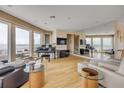 Bright living room with floor-to-ceiling windows, piano and panoramic ocean views at 951 N Atlantic Ave, New Smyrna Beach, FL 32169