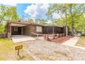 Beautiful brown home with a front porch, landscaped with flowers and gravel at 98 Cypress Pond Rd, Port Orange, FL 32128