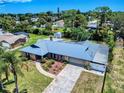 Aerial view of a beautiful house with well-maintained landscaping and a unique metal roof at 108 Dee St, New Smyrna Beach, FL 32168
