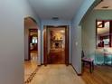 Hallway showcasing archways that lead to a stone fireplace and another room with hardwood flooring at 108 Dee St, New Smyrna Beach, FL 32168