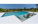 Modern pool with built-in lounge chairs for relaxing in the sun at 113 Pitching Wedge Dr, Daytona Beach, FL 32124