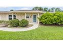 Close-up of the home's front entrance with a well-maintained lawn and landscaping at 125 Orange Ave, Edgewater, FL 32132