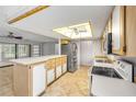 Bright kitchen featuring an island, modern appliances, and ample counter space at 125 Orange Ave, Edgewater, FL 32132