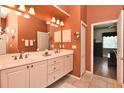 Well-lit bathroom featuring a double vanity, neutral color scheme, and tiled floors at 1442 Carlow Cir, Ormond Beach, FL 32174