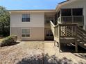 Two-story home with patios and wood stairs offers a welcoming and charming exterior at 1600 Big Tree Rd # L1, South Daytona, FL 32119