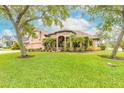 Attractive single-story home with lush green lawn, mature trees, and beautiful landscaping at 1734 Covendale Ln, Port Orange, FL 32128