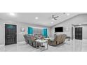 A grey living room featuring recessed lighting, modern furniture, and large windows with blinds at 1845 Willow Oak Dr, Edgewater, FL 32141
