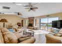 Cozy living room featuring a brick fireplace and waterfront views at 1905 S Riverside Dr, Edgewater, FL 32141