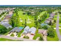 A high aerial showing the house, the golf course, and surrounding community at 2005 Country Club Dr, Port Orange, FL 32128