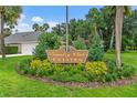 Well-maintained 'Country Club Estates' community sign surrounded by lush landscaping at 2005 Country Club Dr, Port Orange, FL 32128