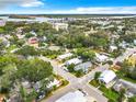 Expansive aerial view showcasing the neighborhood, trees, and distant cityscape and waterway views at 216 Murray St, New Smyrna Beach, FL 32168