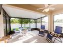 Enclosed outdoor patio featuring a dining set, lounge chairs, and serene views of the backyard at 2818 Taton Trce, New Smyrna Beach, FL 32168