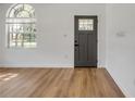 Bright entryway featuring wood-look flooring, a stylish front door, and a window at 2822 Brookline Ave, New Smyrna Beach, FL 32168