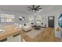 Open living space with stylish furniture, vaulted ceilings, and wood-look flooring at 2822 Brookline Ave, New Smyrna Beach, FL 32168