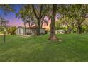 Spacious backyard with mature trees, outbuildings and a picnic table at 2917 Crockett Pt, Sanford, FL 32773