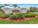Elegant entryway to Townhomes at the Oceans with manicured landscaping and signage at 2961 Oceans Trce, Daytona Beach Shores, FL 32118