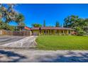 Charming single-story home with a well-maintained lawn, attached garage and covered front porch at 3048 Mango Tree Dr, Edgewater, FL 32141