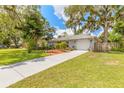 Inviting single-story home featuring a manicured lawn and lovely shade trees providing curb appeal at 3120 Mango Tree Dr, Edgewater, FL 32141